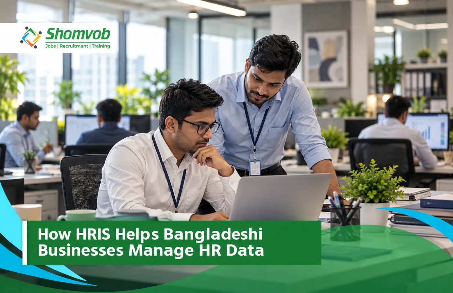 Two HR colleagues reviewing HR data on a laptop in a Bangladeshi office